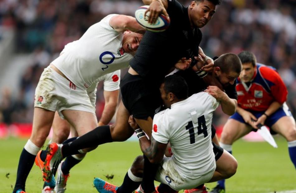 All Black winger Julian Savea is caught by the England defence. REUTERS/Stefan Wermuth