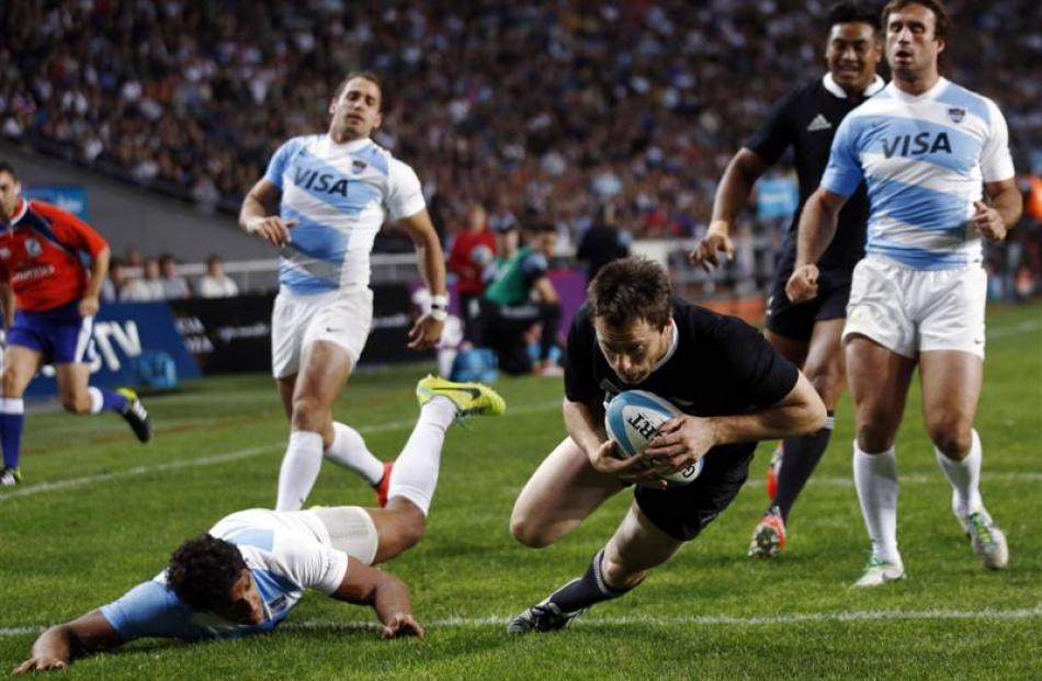 All Blacks wing Ben Smith scores a try against the Pumas in the Rugby Championship match in La...
