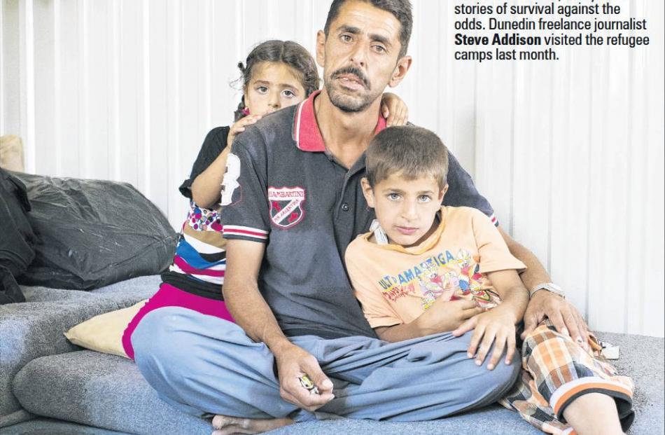 Alla Mustafa with his two children in their home at Azraq refugee camp. Photo by Tim Eastman