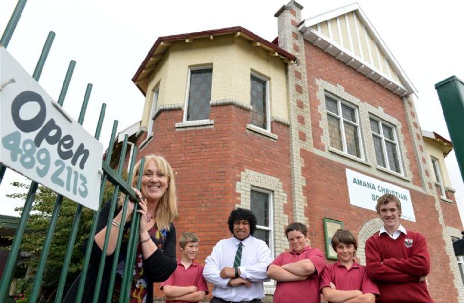 Amana Christian School principal Liz Bishop with pupils (from left) Harry Granger (12), Tim...