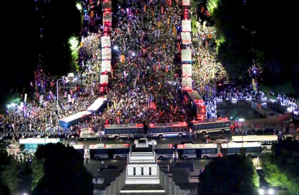 An aerial view shows protesters gathering at a rally against Japan's Prime Minister Shinzo Abe's...