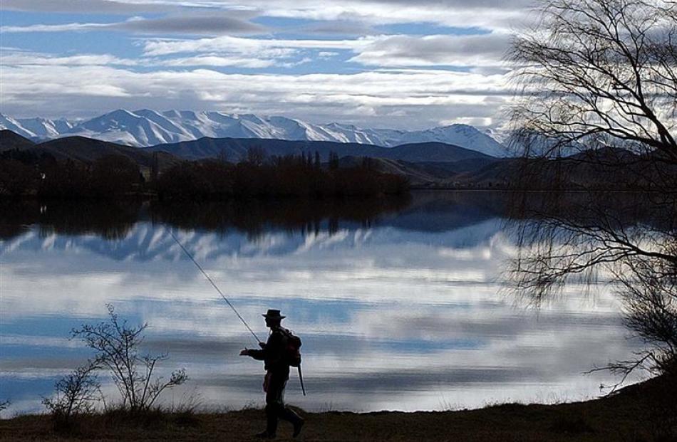 An angler looks for a fishing spot at Lake Benmore's Sailors Cutting near Otematata. Photo by...