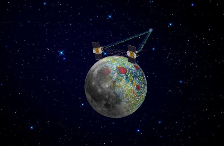 An artist's rendering of twin GRAIL spacecraft in orbit around the moon is shown in a NASA...