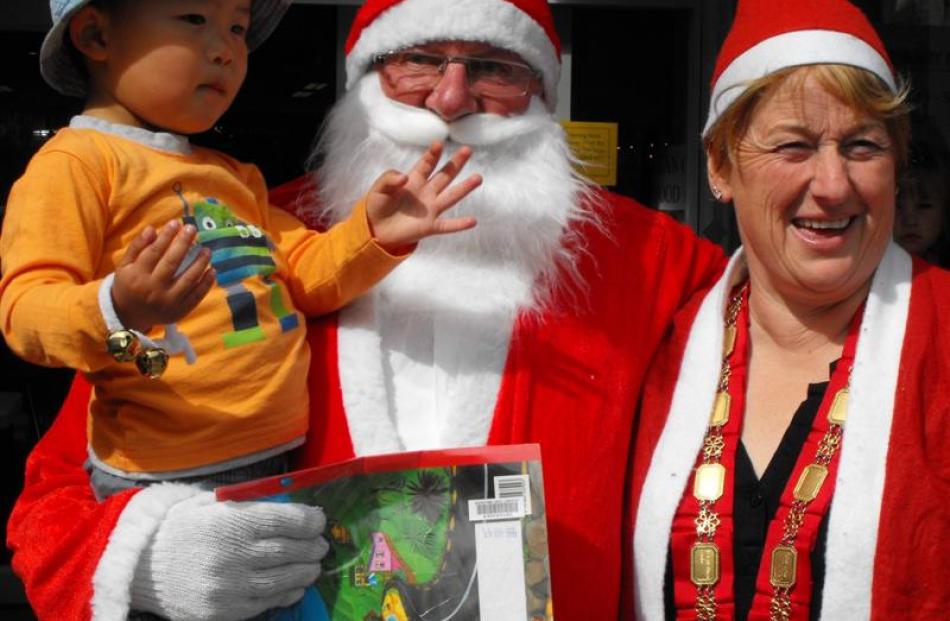 An excited Audric Chai (2) ran up to Santa Claus upon his arrival. Santa was accompanied by Mr....