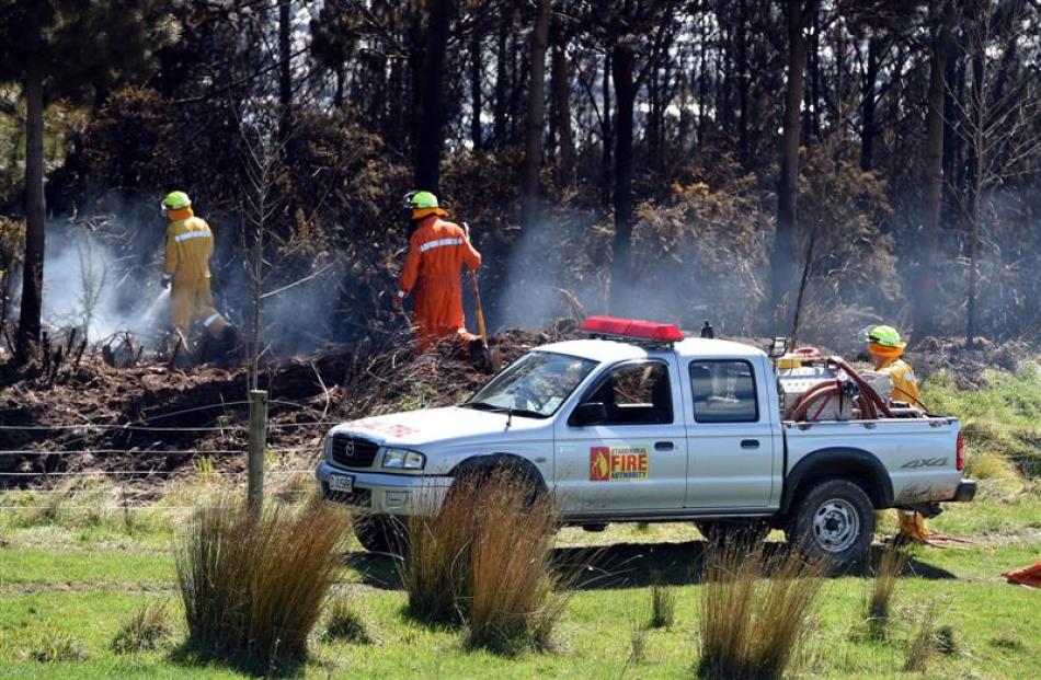 An Otago rural fire crew extinguishes  small hotspots which flared up in a forestry block off...