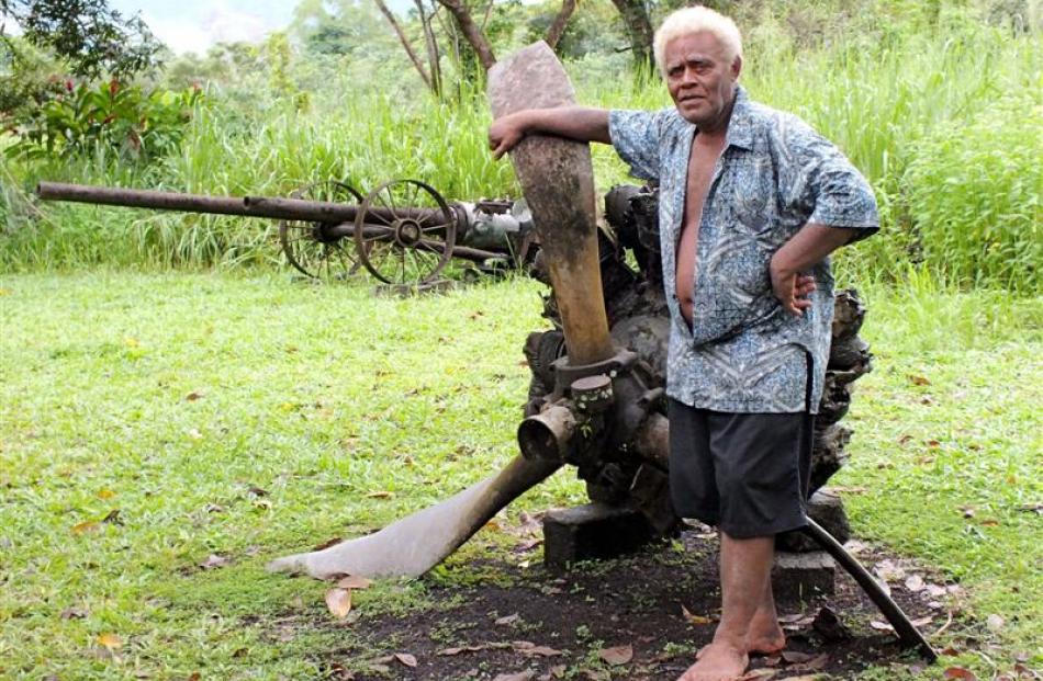 Anderson Dua  stands by the remains of a Japanese bomber. Photos by Gillian Vine.