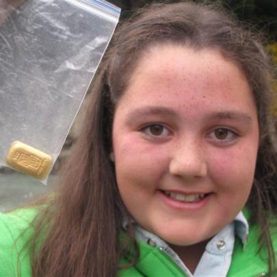 Andie Gillings, of Queenstown, digs for gold on the banks of the Shotover River on Saturday...