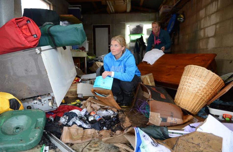 Anna Bartlett inspects her flood-damaged property in her Kinmont Park garage yesterday with...