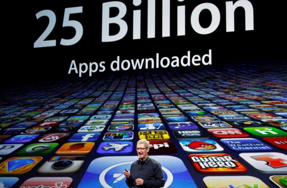 Apple CEO Tim Cook speaks about the number of Apps downloaded during a March 2012 event in San...