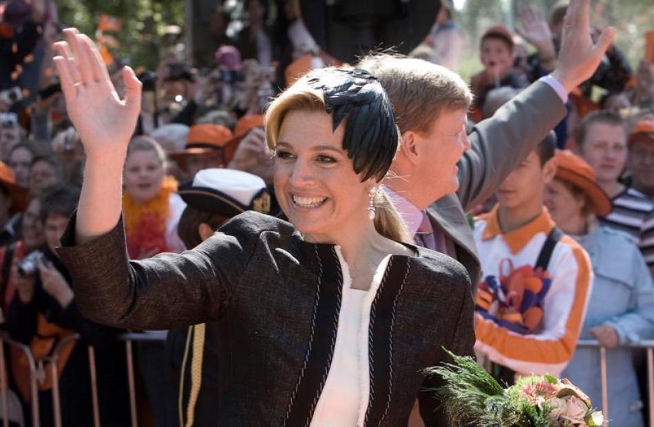Argentinian-born Princess Maxima and her husband Crown Prince Willem Alexander wave before the...