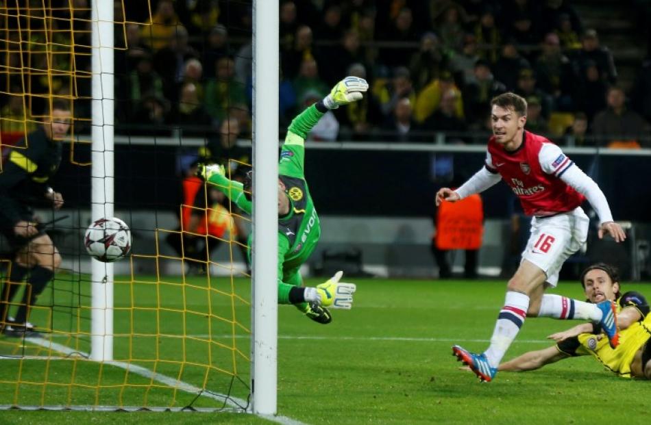Arsenal's Aaron Ramsey (R) scores past Borussia Dortmund's goalkeeper Roman Weidenfeller. REUTERS...