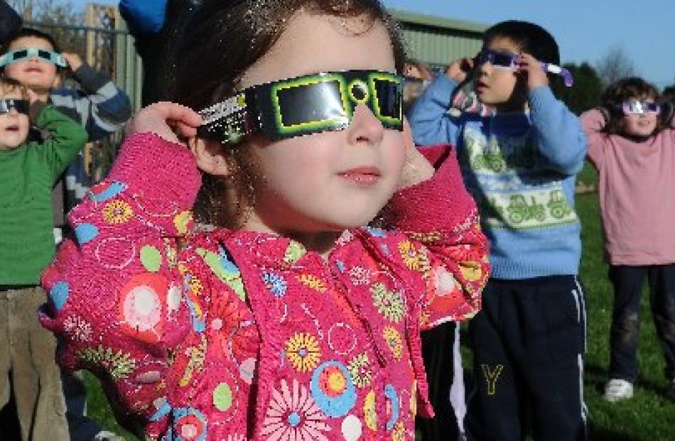 Arthur Burns Preschool pupil Isabel Koning (3,  left), of Mosgiel, follows the transit of Venus...