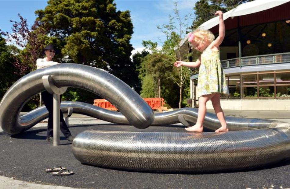 Artist Julia Morison watches Imogen Bailey (3), of Dunedin, playing on the flexible worm after...