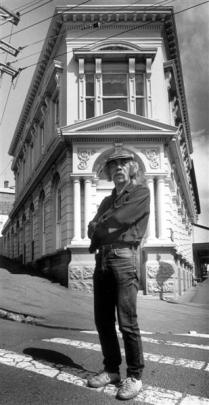Artist Ralph Hotere stands outside a new gallery and studio, the former Bank of New Zealand...