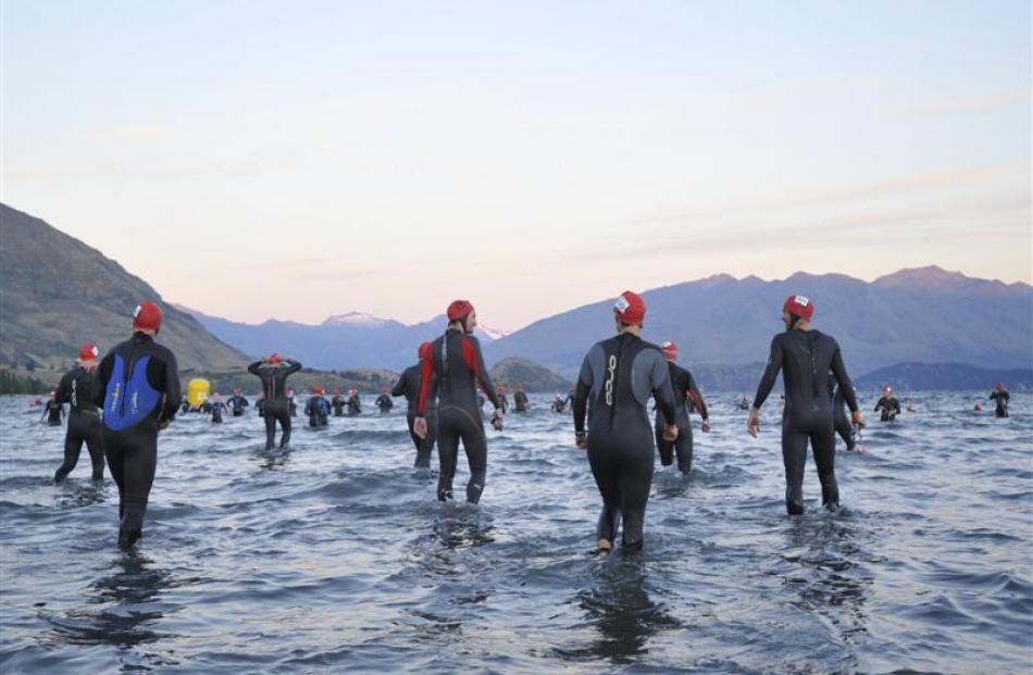 Athletes check the temperature of Lake Wanaka  before the start of the Challenge Wanaka 2012 swim...