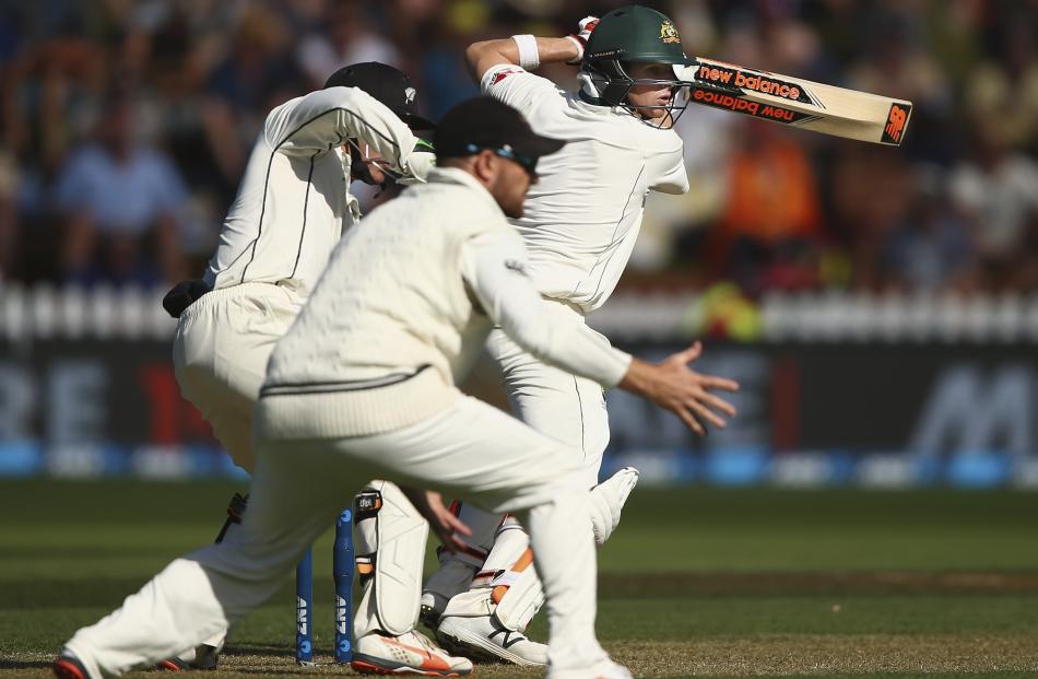 Australia captain Steve Smith clips a delivery through the offside, watched by Black Caps...