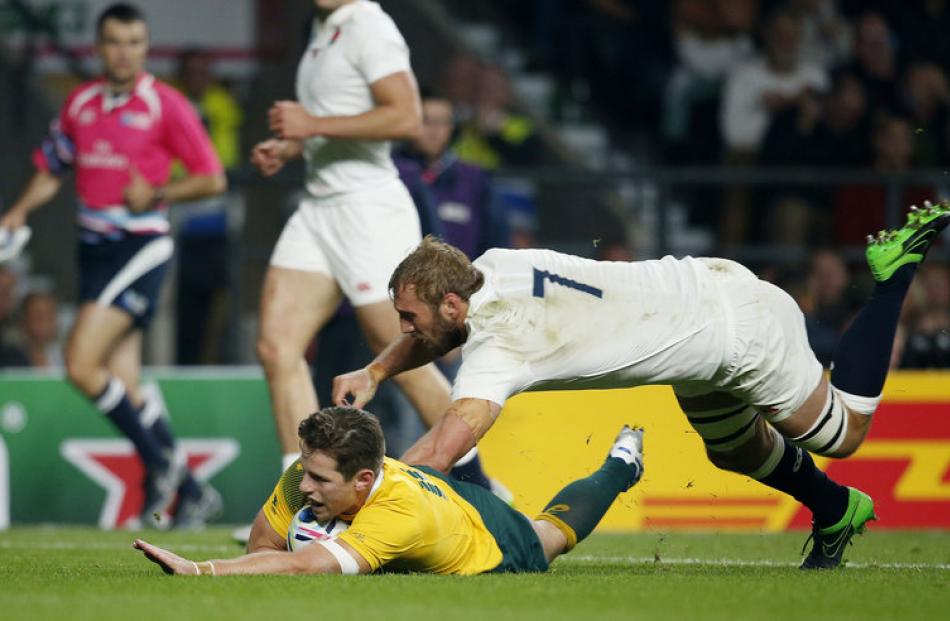 Australia first five Bernard Foley scores the first try of the game. Photo: Reuters