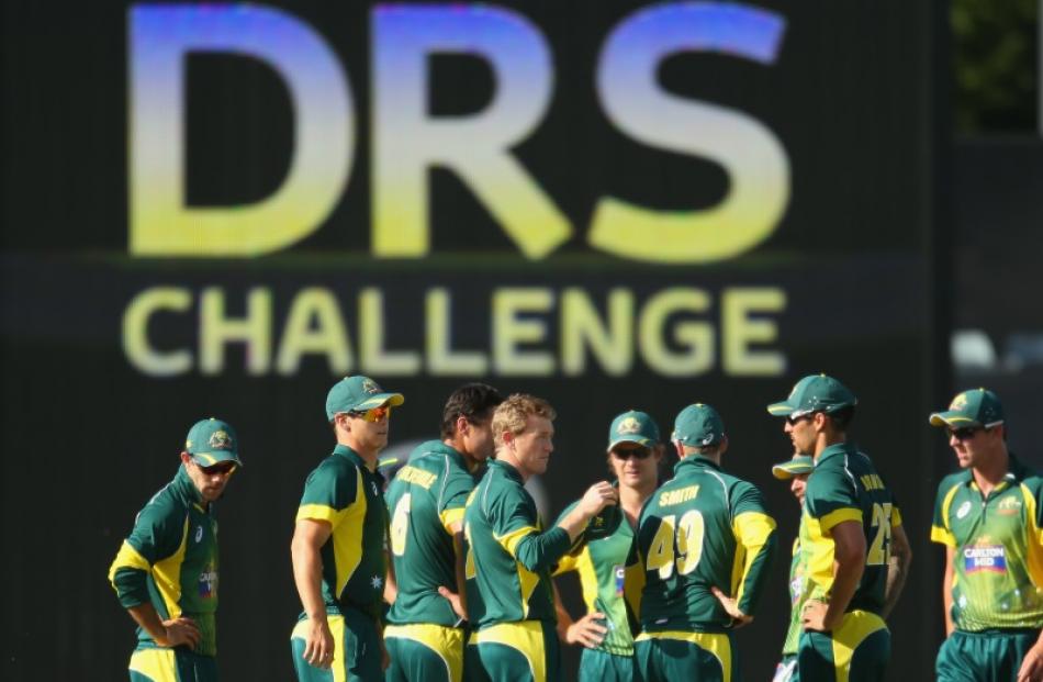 Australia players wait after using a DRS challenge. Photo: Getty Images