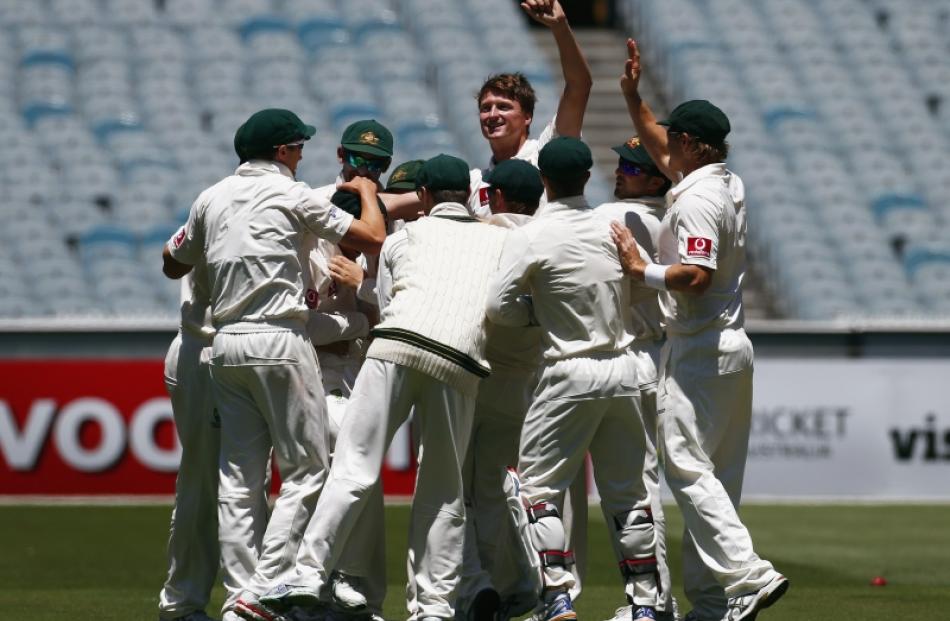 Australia's Jackson Bird (centre) celebrates with team mates after taking the wicket of Sri Lanka...