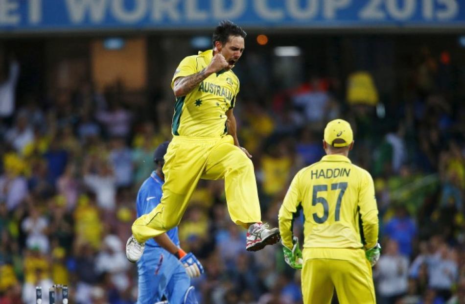 Australia's Mitchell Johnson celebrates after bowling out India's Rohit Sharma. REUTERS/David Gray