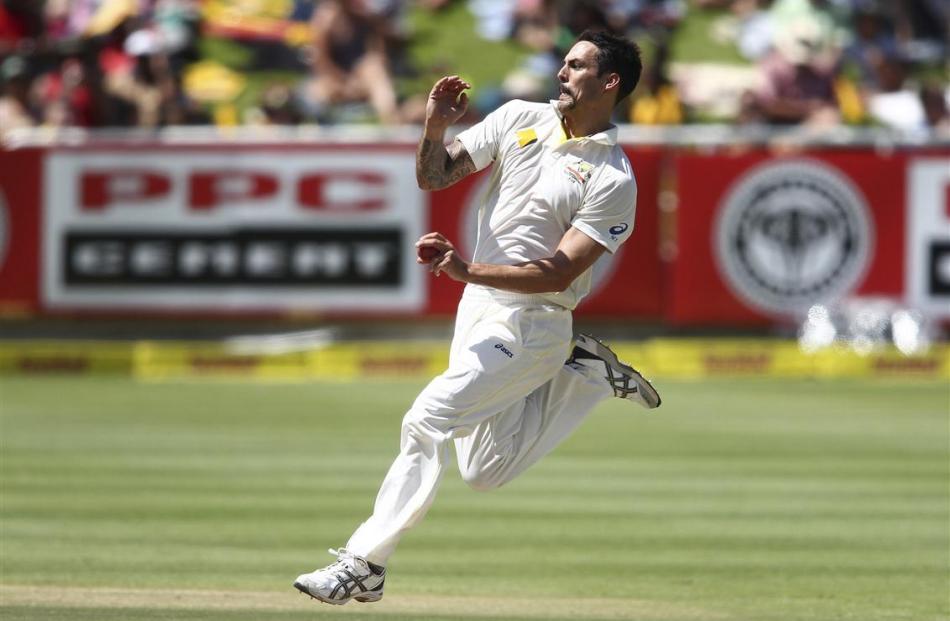 Australia's Mitchell Johnson sends down a delivery during the third day of the third test cricket...