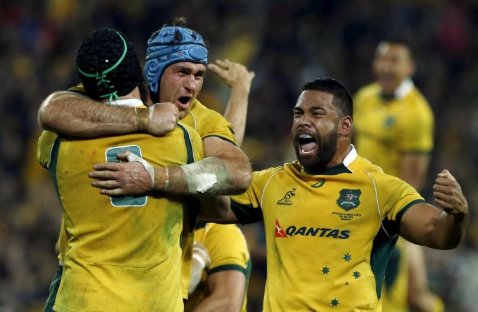 Australian players celebrate a try during their win over South Africa in Brisbane earlier this...