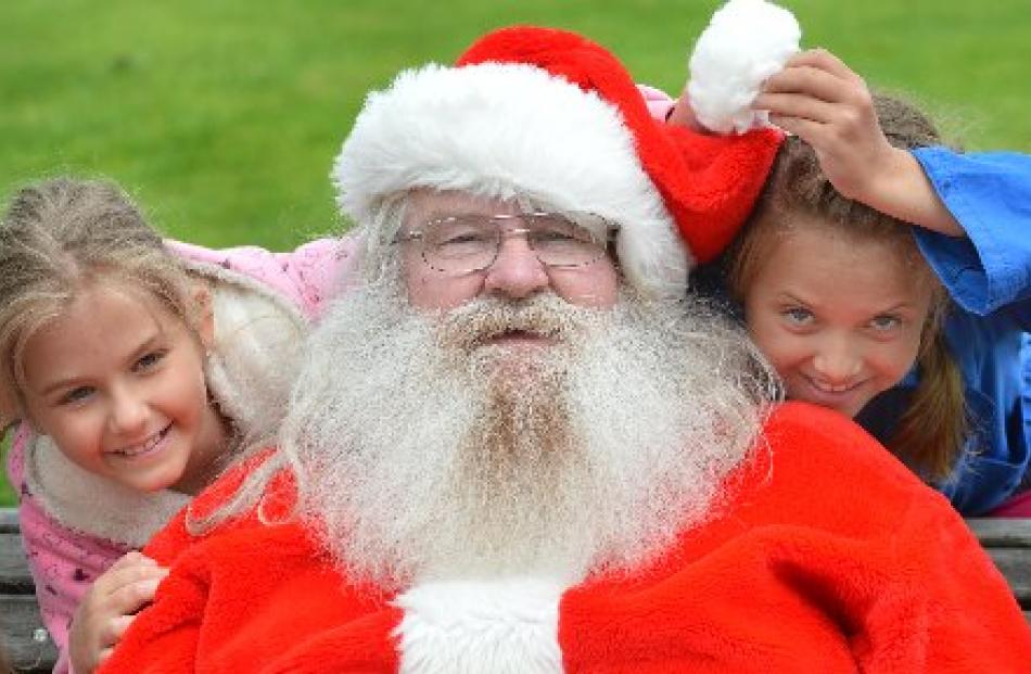 Australian tourists Natalia (8) and Anastasia (9) Chochol, of Brisbane, meet Santa (Graeme...
