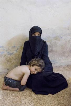 Aysha Qwasem Rahhal (5) and her mother in their Amman home. Photos by Tim Eastman.