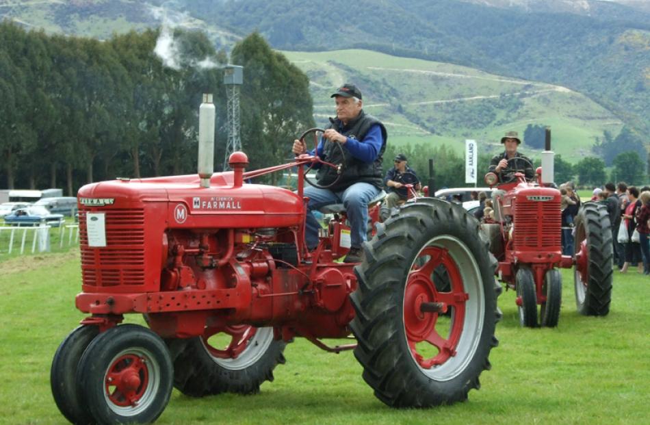 Scottie Birse, of Tapanui, leads a group of vintage Farmall tractors.