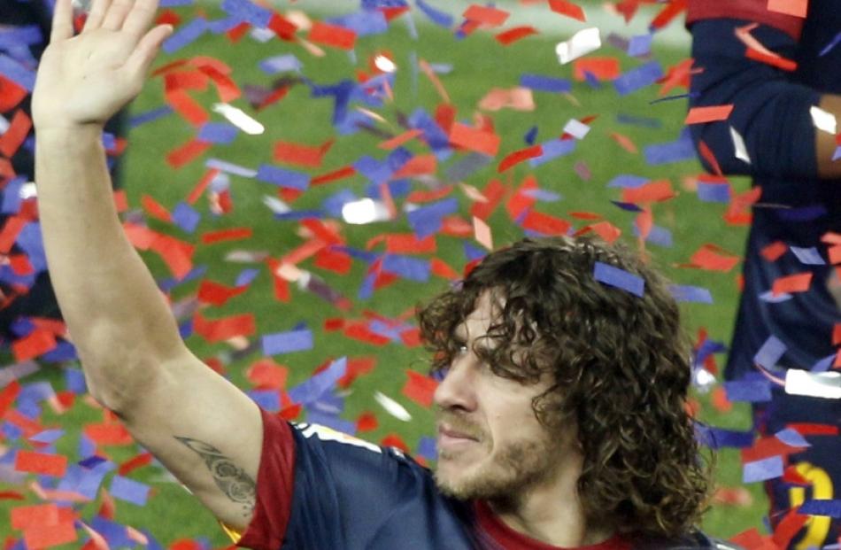 Barcelona's captain Carles Puyol waves to the team's supporters during the Spanish league first...