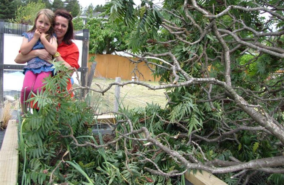 Bella (5) and Belinda Thomlinson with their destroyed vege patch after a high-wind vortex hit...