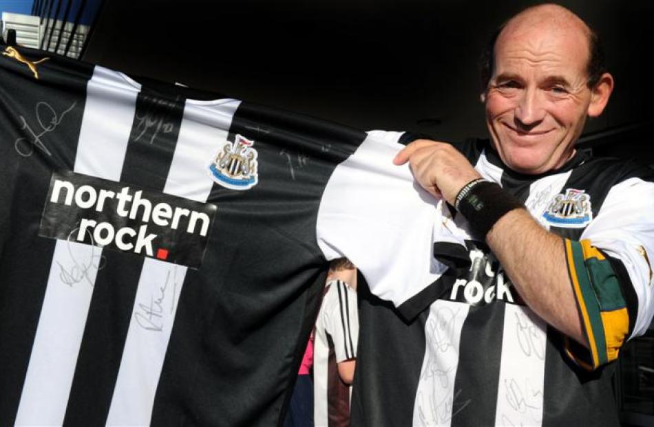 Ben Buist, of Christchurch, displays the signed Newcastle United shirt he plans to give  to the...