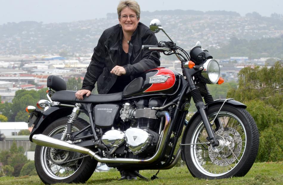 Dunedin City Council chief executive Dr Sue Bidrose stands with her retro-styled 2009 Triumph...