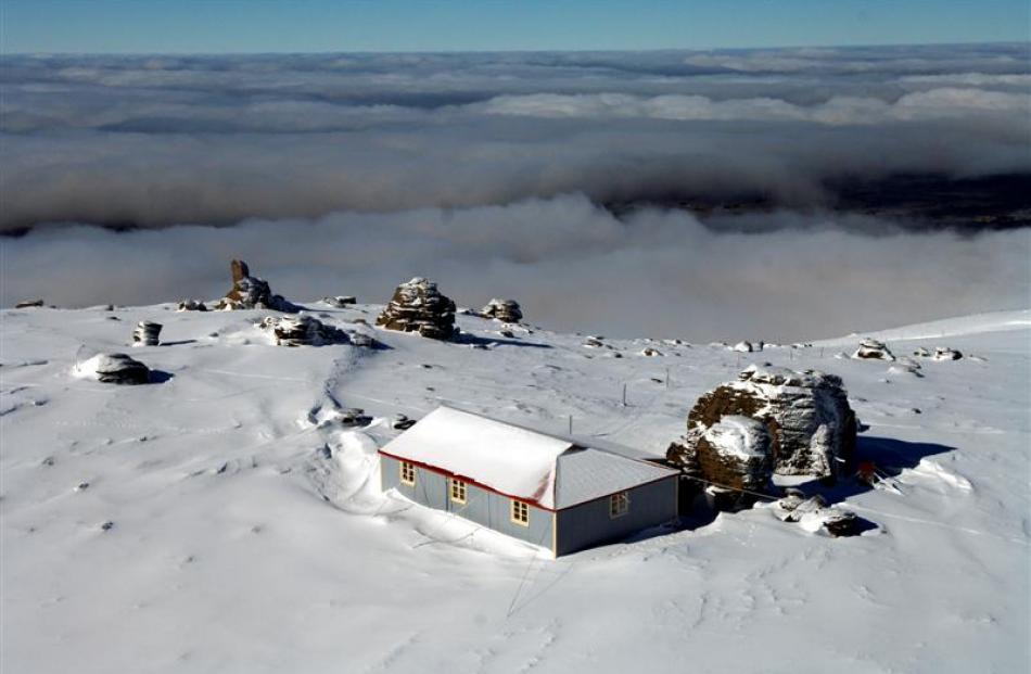 Big Hut in winter in 2007.  The Strath Taieri lies below the clouds. Photo by Stephen Jaquiery.