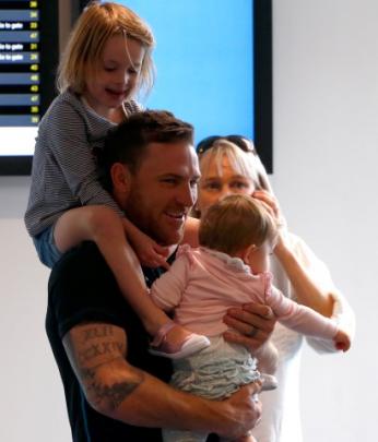 Black Caps captain Brendon McCullum holds his daughters after arriving at Auckland Airport today....