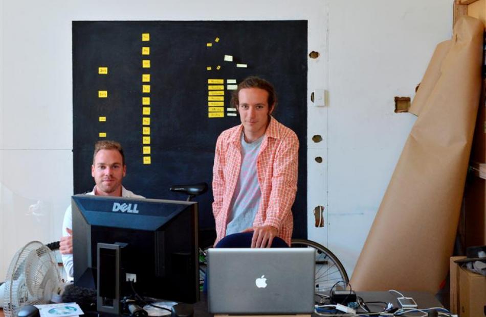 Blue Oyster Art Project Space director Jamie Hanton (left) watches artist Max Bellamy editing his...