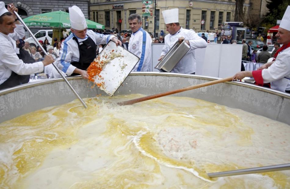 Bosnian chefs cook in a Guinness Book of World Records attempt for the largest chicken broth, in...