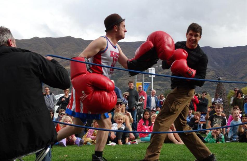 Boxing busker and professional clown Fraser Hooper (left), of Wellington, takes on Wanaka man...