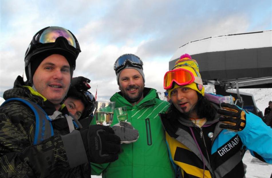 Brendon Cameron, Karl Hunt and Eddy Lecotey, all of Queenstown, make the most of the free bubbly...