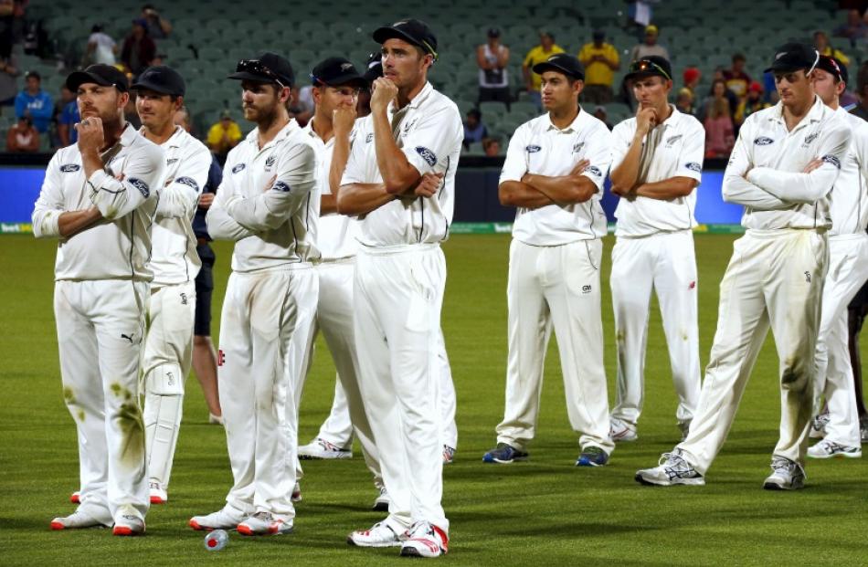 Brendon McCullum (far left) stands with team mates after losing the third test against Australia...