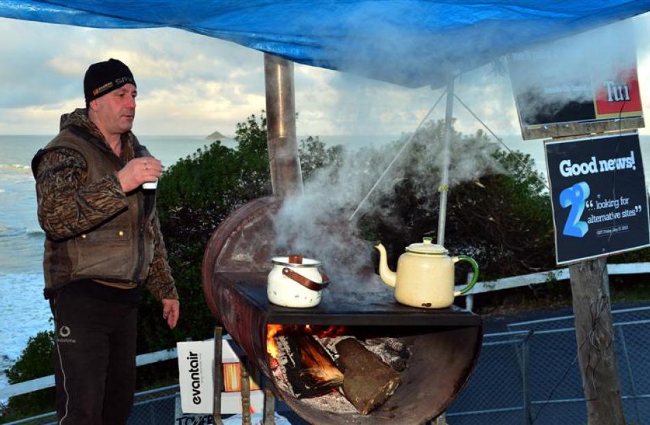 Brighton resident Neil Bush holds  a cup of a tea yesterday while  protesting against the...
