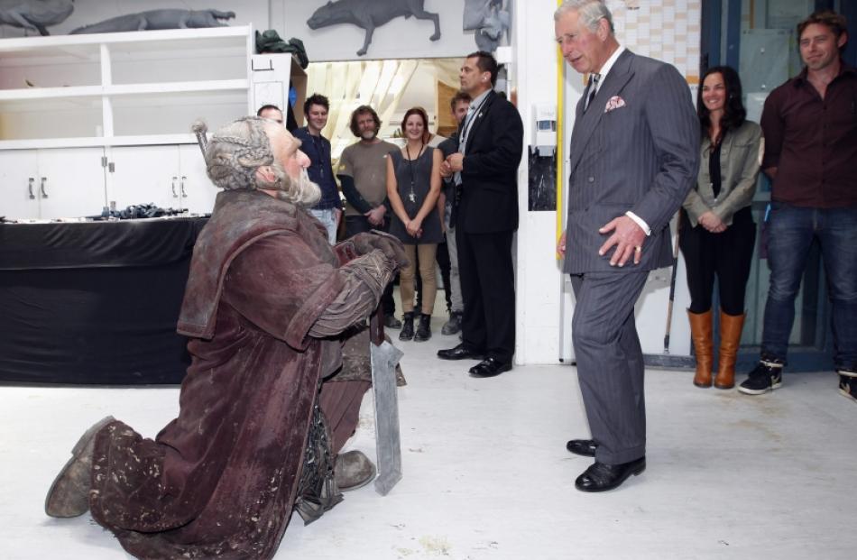 Britain's Prince Charles reacts as he meets Dori (left), a dwarf character from The Hobbit,...