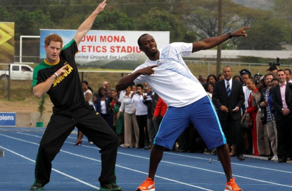 Britain's Prince Harry (L) and Olympic gold medallist Usain Bolt pose at the Usain Bolt track at...