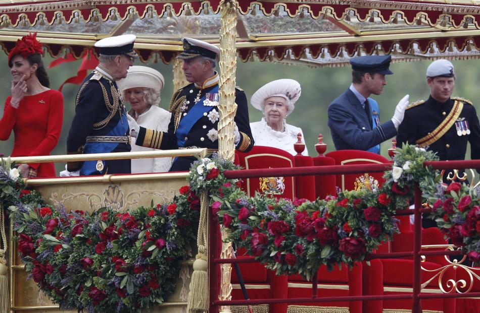 Britain's Queen Elizabeth watches from onboard the Spirit of Chartwell with other members of the...