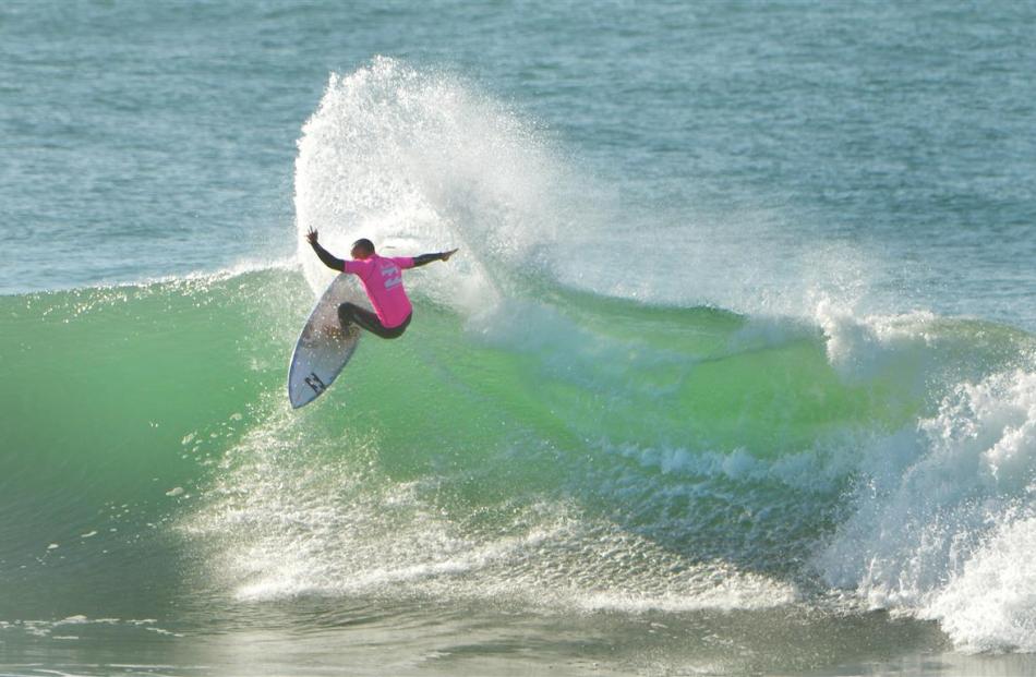 Buck Woods, of Gisborne, catches a wave at the first day of the national surfing championships at...