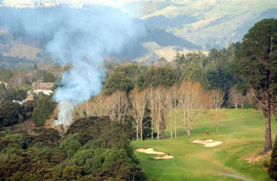 Burning ... Smoke drifts across the city as dead trees are burnt off at the Otago Golf Club on...