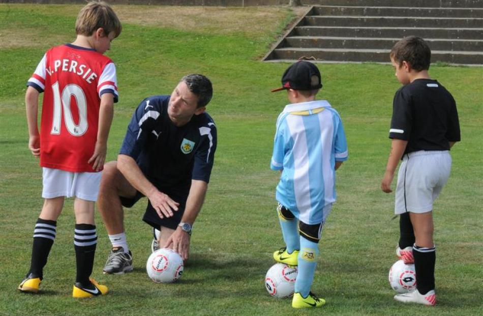 Burnley head of youth for Australasia Paul Wozny talks with (from left) Oliver Colloty (9),...