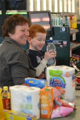 Cameron Gillies (6) visits Mosgiel New World to learn from operator Debbie Wilson how to use the...