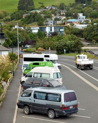 Campervans and vehicles in which people are sleeping line up at Macandrew Bay early yesterday in...