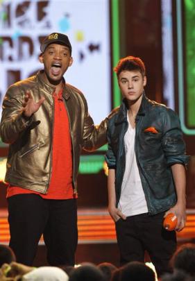 Canadian singer Justin Bieber and actor Will Smith are slimed on stage at Nickelodeon's 25th...